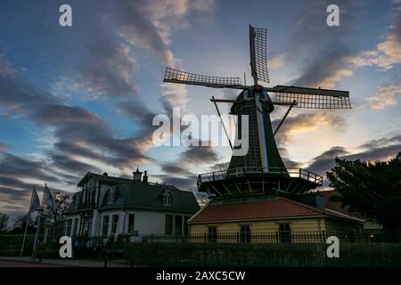 Dutch windmill against a beautiful evening sky near Lake `Kralingse Plas` in Rotterdam, Holland. Stock Photo